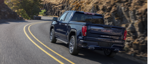 Blue GMC Sierra on a curvy mountain road